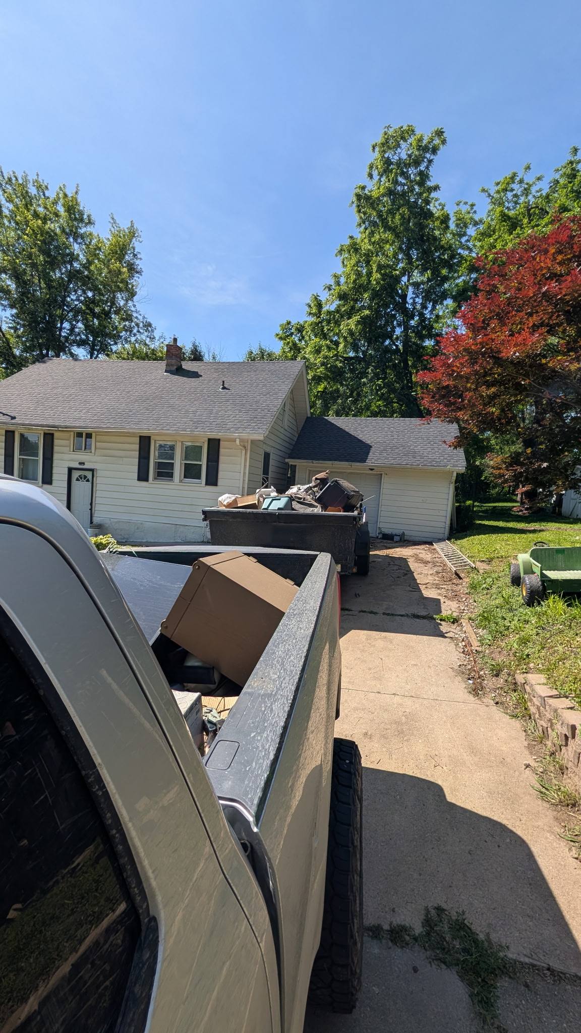 Two loaded trailers at a residential job site