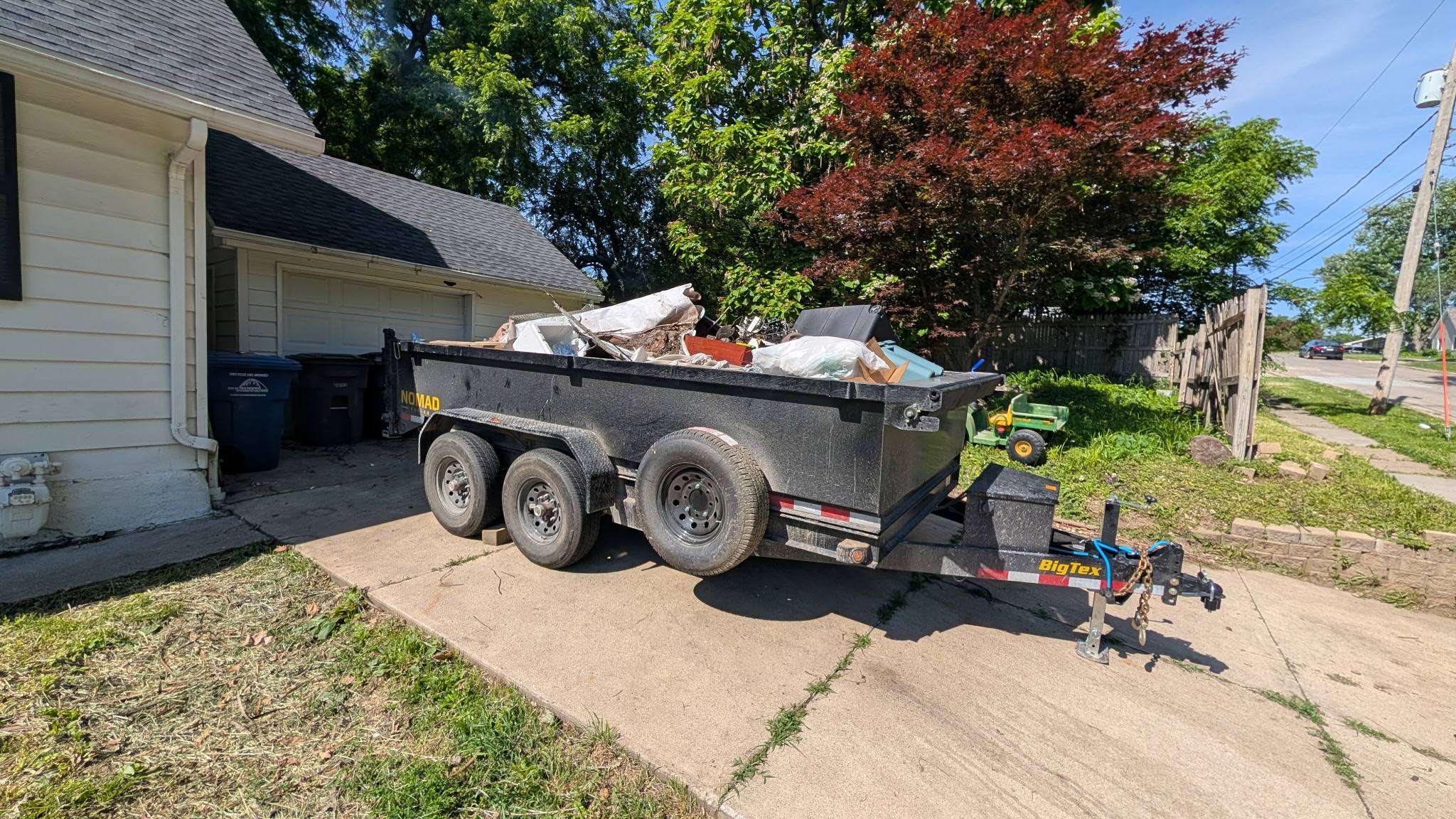 Loaded dump trailer parked in residential driveway